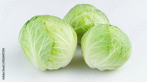 Fresh green cabbage heads arranged on a clean white background showcasing their crisp leaves and natural texture for culinary uses