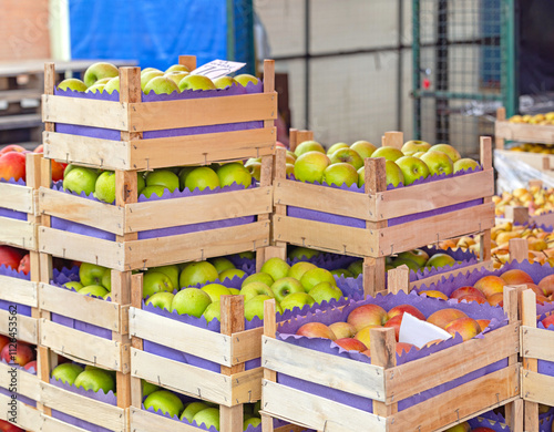 Stacks of Apples Fruits in Wooden Crates at Farmers Market