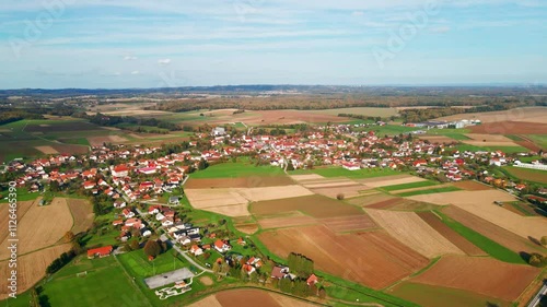 Stunning drone 4K video of a rural countryside of Northeastern Slovenia. A agricultural landscape with small settlement in the back. Scene filmed in autumn highlights countryside life from above. photo