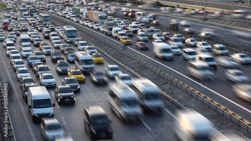 City traffic time lapse in sunset. City traffic at rush hour. Heavy evening traffic. Cars trying to reach home at rush hour. Blurred background and glittering chaos. 