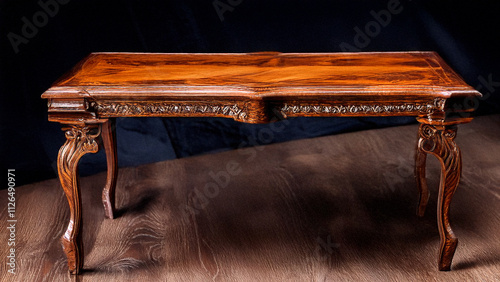 Expensive antique furniture. The table is coated with epoxy resin and varnished. Luxurious quality woodworking. Wooden table on a dark background. On a rectangular wooden plate