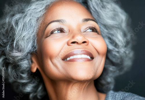 Portrait of an elegant senior woman with silver hair and a radiant smile, symbolizing confidence and timeless beauty.  photo