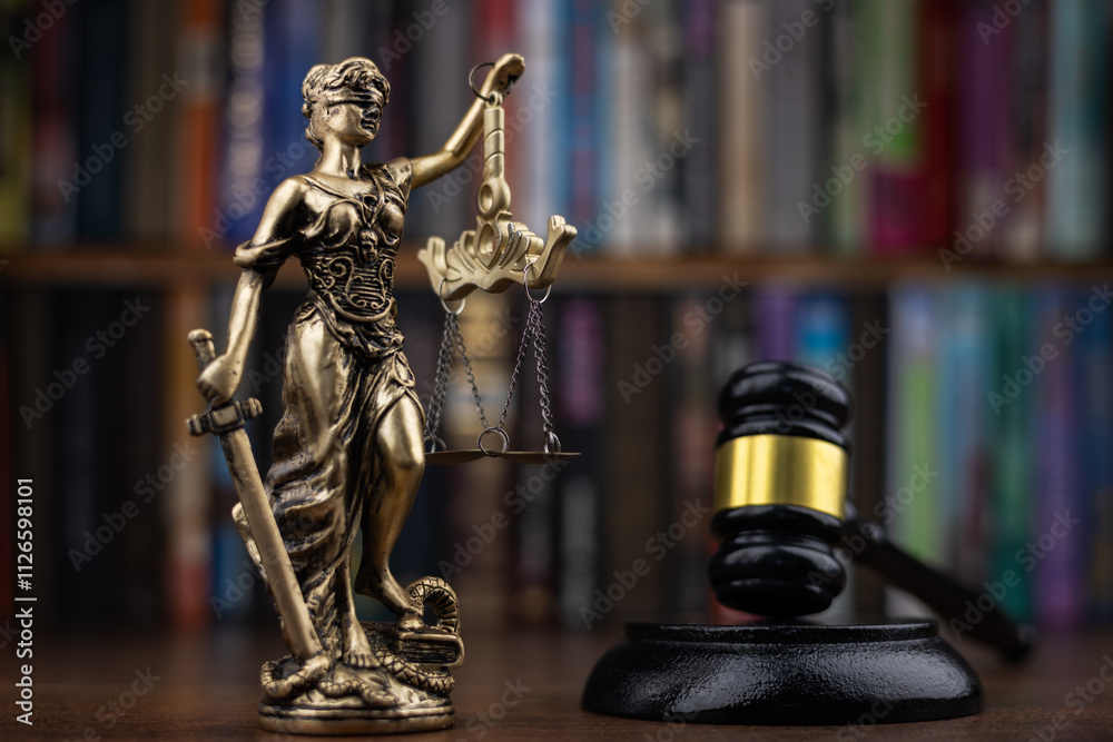 Judge's gavel on Themis statue background. Law theme concept. Mallet of the judge for sentencing Judge's gavel on Themis statue background. Law theme concept. Mallet of the judge for sentencing