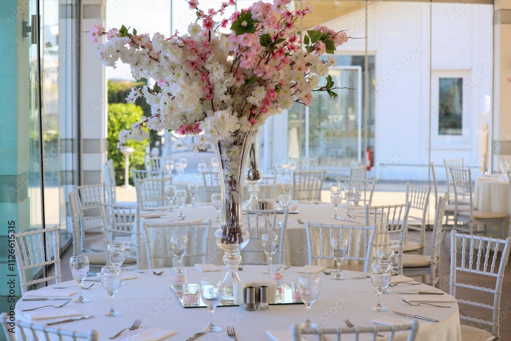 Elegant Outdoor Wedding Reception with Long Tables, White Decor, and Colorful Floral Runner