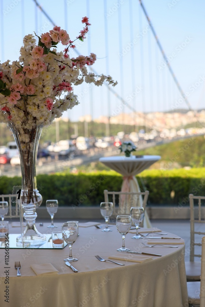 Elegant Outdoor Wedding Reception with Long Tables, White Decor, and Colorful Floral Runner