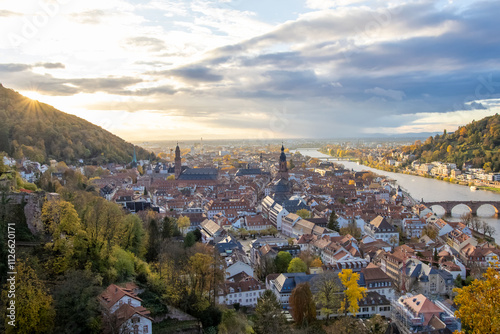 A Breathtaking View of the City at Sunset with the Sunlight Reflecting on Houses and the River photo