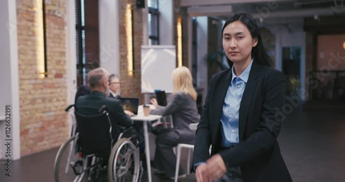 Young Asian businesswoman with brunette hair crosses arms