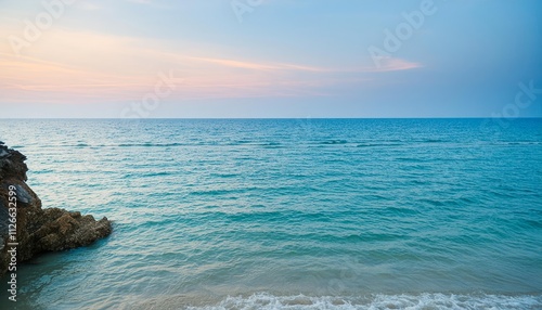 Captivating Beauty of Nature: Blue Sea and Pink Sky at Sunset - A Serene Coastal Scene Highlighting the Harmony of Colors and Tranquility of Ocean Waves