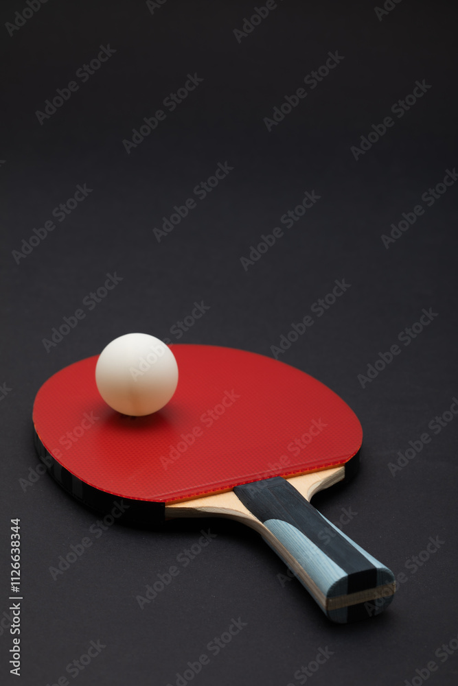 Professional Red Table Tennis Paddle with Competition Ball on Dark Background