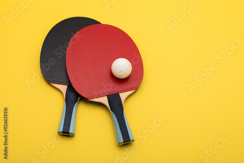 Professional Table Tennis Rackets and Ball Set Against Yellow Background