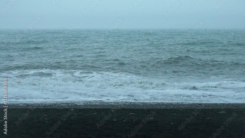 Incoming waves along the Reynisfjara Black Sand Beach coastline Incoming waves along the Reynisfjara Black Sand Beach coastline