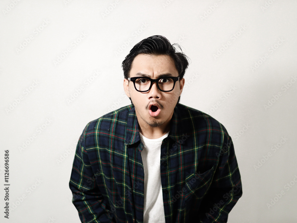 Adult Asian man looking to camera with angry expression isolated on white background Adult Asian man looking to camera with angry expression isolated on white background