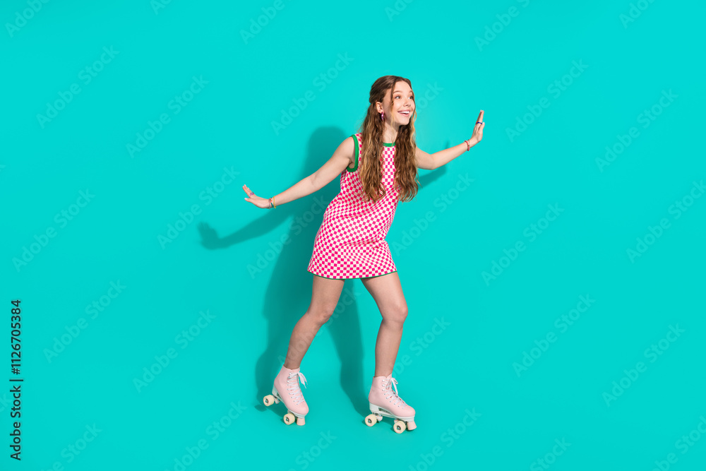 Naklejka premium Full size photo of pretty teen girl ride roller cheerful have fun wear trendy plaid pink outfit isolated on cyan color background