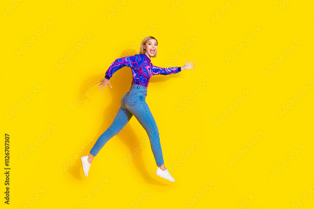 Full size photo of pretty young girl run excited black friday wear trendy colorful blue outfit isolated on yellow color background Full size photo of pretty young girl run excited black friday wear trendy colorful blue outfit isolated on yellow color background
