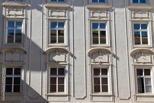 Baroque-Style Building Facade with Ornate Moldings and Symmetrical Windows