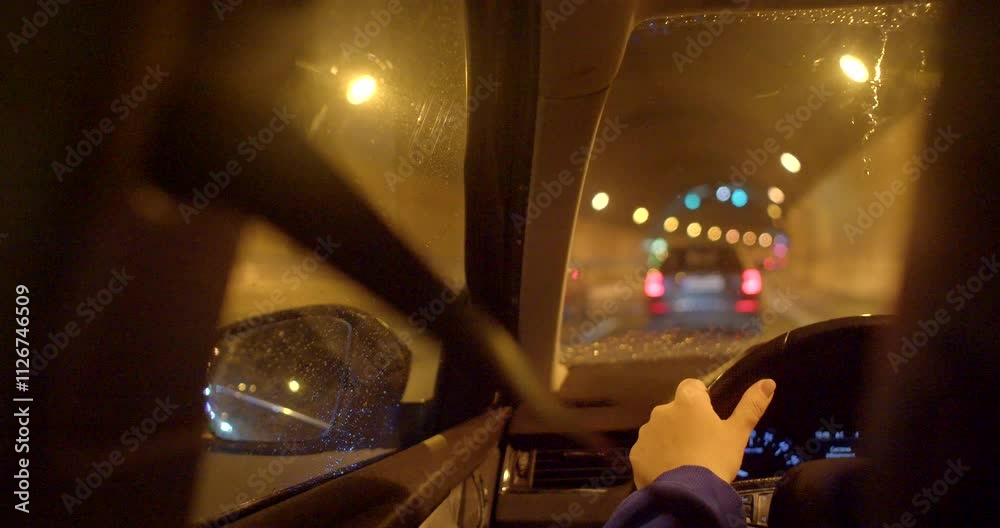 Driving at night is in a tunnel with traffic lights and a blurred backdrop from the speed Driving at night is in a tunnel with traffic lights and a blurred backdrop from the speed