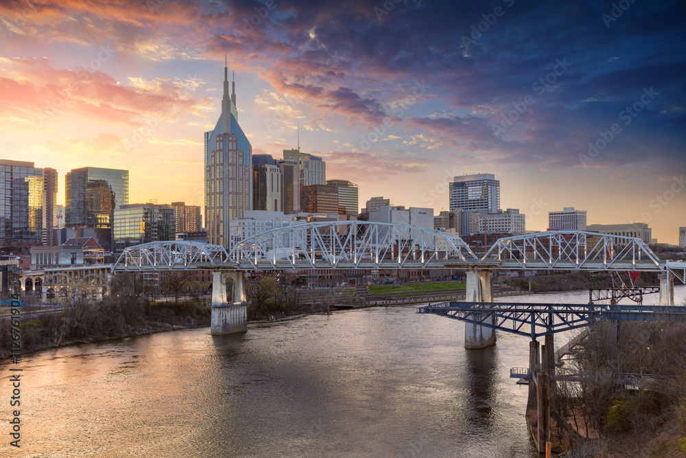 Nashville, Tennessee, USA. Cityscape image of Nashville, Tennessee, USA downtown skyline with reflection of the city the Cumberland River at spring sunset.