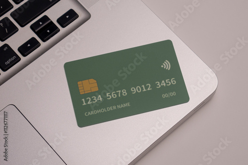 Close up of debit and credit cards placed in front of laptop. online shopping payment and retail concept. mockups and fake credit cards. Color credit card.