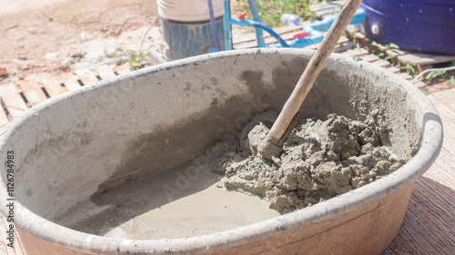 Cement mixed with sand in a cement container with shovel tool for work