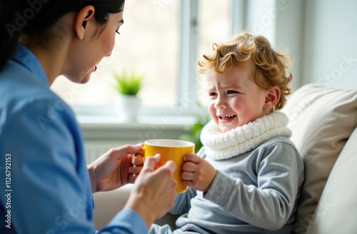 Wallpaper Mural Asian female doctor in medical gown giving hot drink in mug to sick little curly boy. Torontodigital.ca