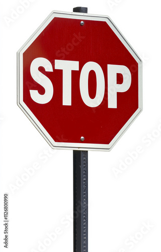 Stop sign positioned at a street intersection. A red stop sign stands tall at an intersection, signaling vehicles to halt. Clear visibility ensures road safety.