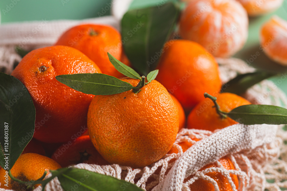 Clementine tangerines close up with green leaves
Clementine tangerines close up with green leaves