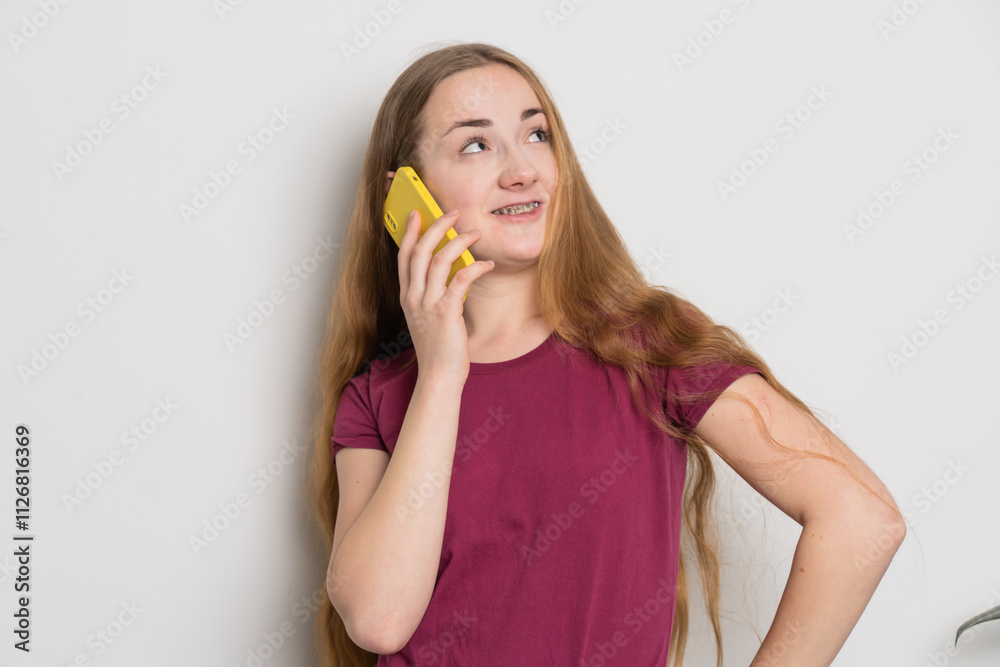 Young beautiful girl uses modern smartphone at home Young beautiful girl uses modern smartphone at home