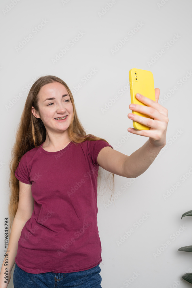Young beautiful girl uses modern smartphone at home Young beautiful girl uses modern smartphone at home