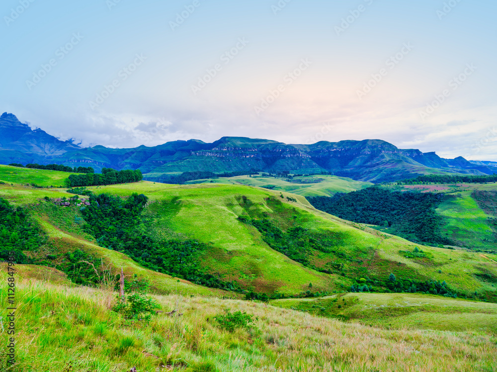 Scenic and tranquil landscape of rolling hills and mountains in Drakensberg, KwaZulu-Natal, South Africa Scenic and tranquil landscape of rolling hills and mountains in Drakensberg, KwaZulu-Natal, South Africa