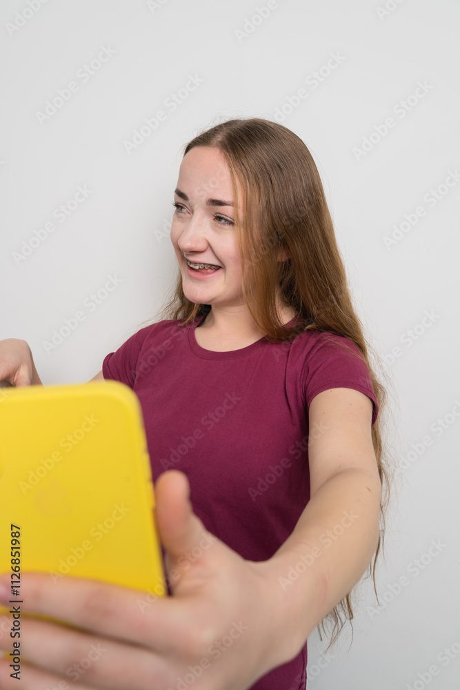 Young beautiful girl uses modern smartphone at home Young beautiful girl uses modern smartphone at home