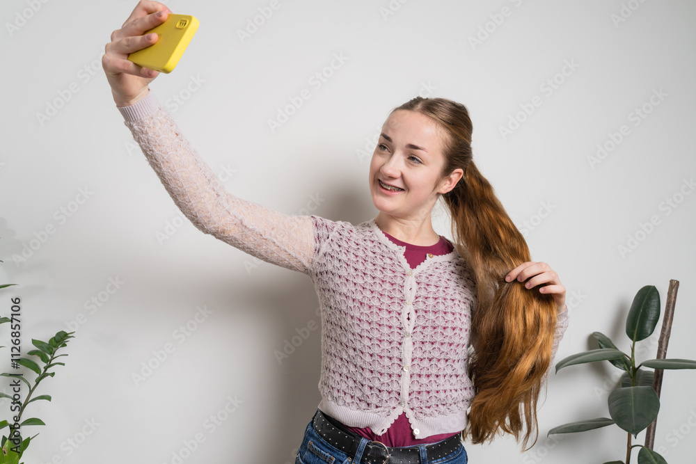 Young beautiful girl uses modern smartphone at home Young beautiful girl uses modern smartphone at home