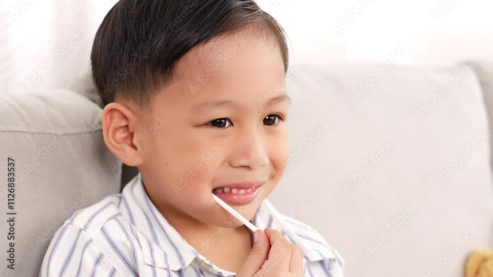 Smile Cute toddler asian little boy eating lollipop or candy It is bad thing of sugar on teeth, Can use for Advertising, dental care concept Smile Cute toddler asian little boy eating lollipop or candy It is bad thing of sugar on teeth, Can use for Advertising, dental care concept
