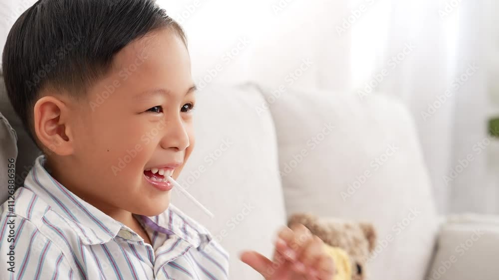 Smile Cute toddler asian little boy eating lollipop or candy It is bad thing of sugar on teeth, Can use for Advertising, dental care concept Smile Cute toddler asian little boy eating lollipop or candy It is bad thing of sugar on teeth, Can use for Advertising, dental care concept