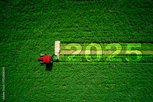 2025 Happy New Year concept and red tractor mowing green field.