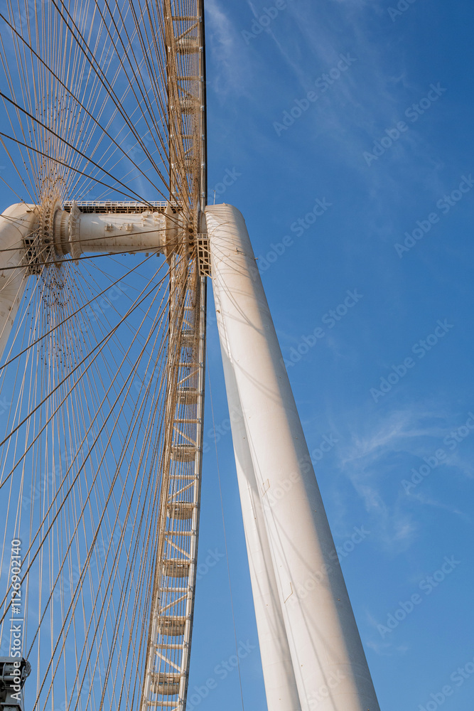 Part of Ferris wheel against the backdrop of a blue sky and the Persian Gulf. Dubai Part of Ferris wheel against the backdrop of a blue sky and the Persian Gulf. Dubai