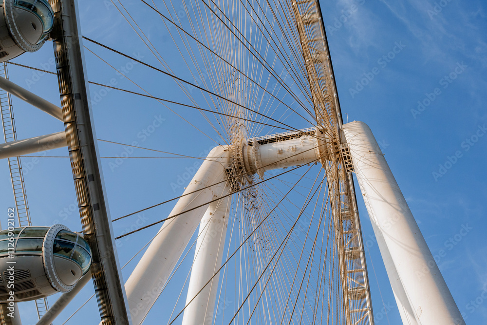 Part of Ferris wheel against the backdrop of a blue sky and the Persian Gulf. Dubai Part of Ferris wheel against the backdrop of a blue sky and the Persian Gulf. Dubai