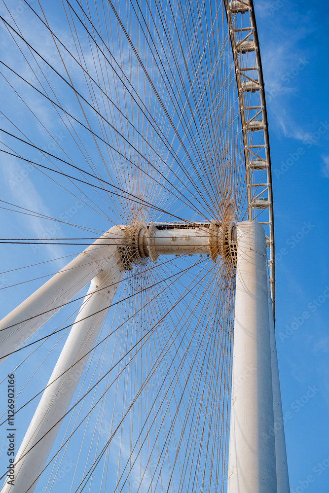 Naklejka premium Part of Ferris wheel against the backdrop of a blue sky and the Persian Gulf. Dubai