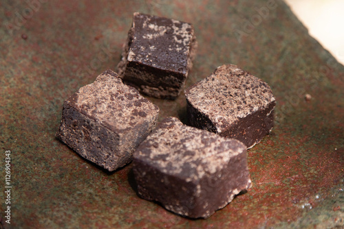 Organic chocolate from the Oaxaca region of Mexico produced in a traditional way on a metate, an ancient stone tool for grinding products. photo