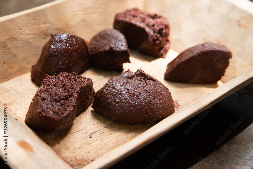 Organic chocolate from the Oaxaca region of Mexico produced in a traditional way on a metate, an ancient stone tool for grinding products. Organic chocolate from the Oaxaca region of Mexico produced in a traditional way on a metate, an ancient stone tool for grinding products.