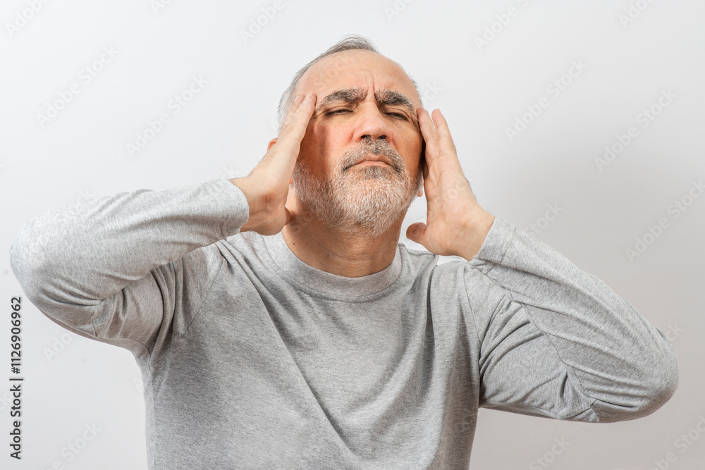 Mature man clutching his head with his hands. Older man suffers from headache, forgetfulness, memory problems. Mature man clutching his head with his hands. Older man suffers from headache, forgetfulness, memory problems.