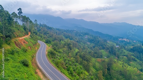 Serpentine Road Through Lush Green Hills in Mountain Landscape