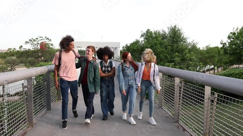 Adolescents walking on bridge highlighting marginality and social struggles photo