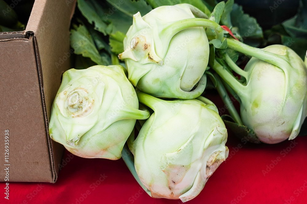 Unique green kohlrabi vegetables displayed at a local farmer's market during the morning hours Unique green kohlrabi vegetables displayed at a local farmer's market during the morning hours