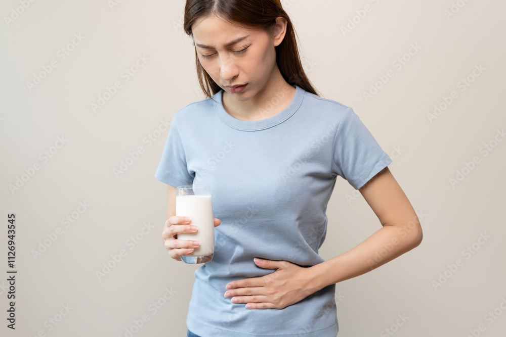 lactose intolerance concept. Woman holding a glass of milk and having a stomachache. lactose intolerance concept. Woman holding a glass of milk and having a stomachache.