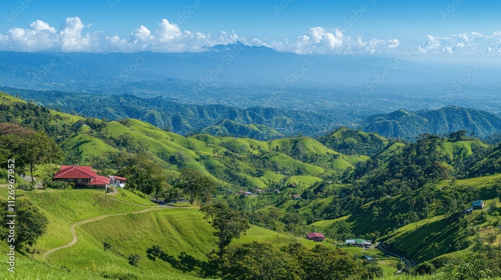 Fototapeta premium A scenic landscape featuring rolling green hills and distant mountains under a clear blue sky.