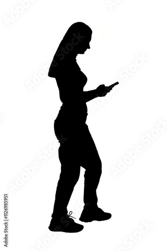  silhouette of a woman walkin and looking her smartphone