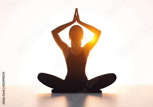 A silhouette of a person practicing yoga in a meditative pose against a bright background.