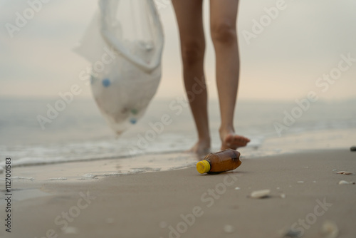 Save water. Volunteer pick up trash garbage at the beach and plastic bottles are difficult decompose prevent harm aquatic life. Earth, Environment, Greening planet, reduce global warming, Save worl photo