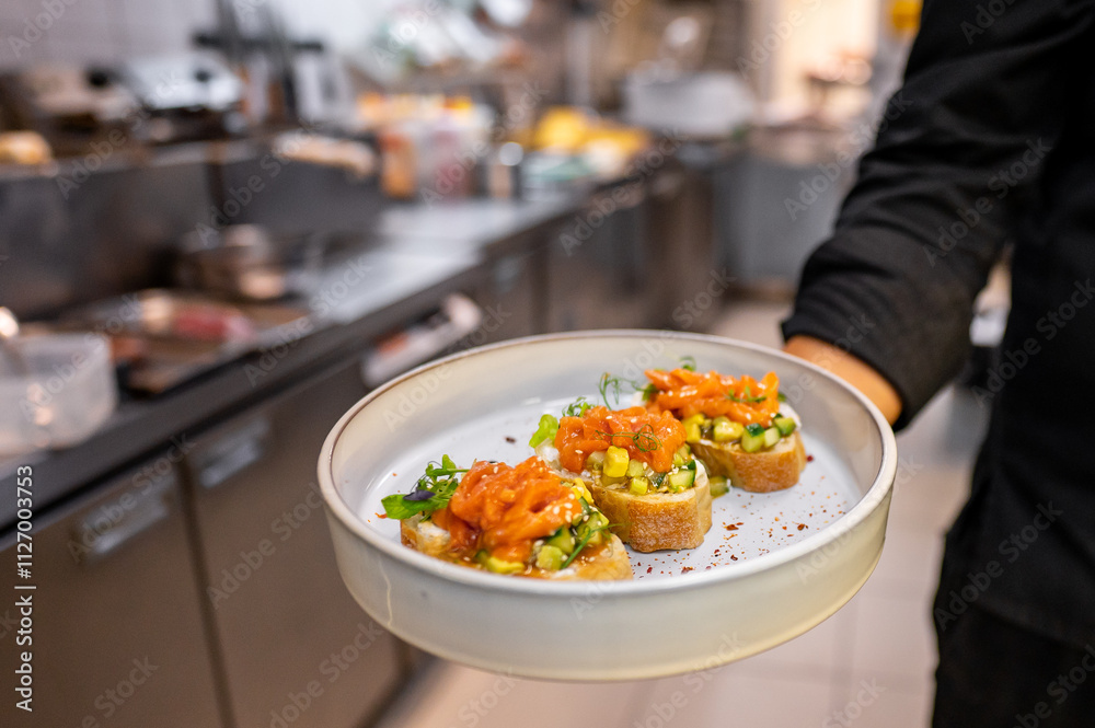 A chef presents a plate of gourmet appetizers featuring smoked salmon, fresh vegetables, and herbs. The vibrant dish is set against a bustling kitchen background, showcasing culinary artistry. A chef presents a plate of gourmet appetizers featuring smoked salmon, fresh vegetables, and herbs. The vibrant dish is set against a bustling kitchen background, showcasing culinary artistry.