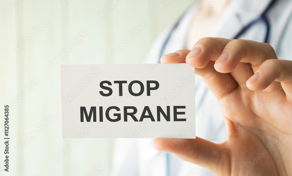 Doctor holding a card with Stop Migraine, medical concept Doctor holding a card with Stop Migraine, medical concept